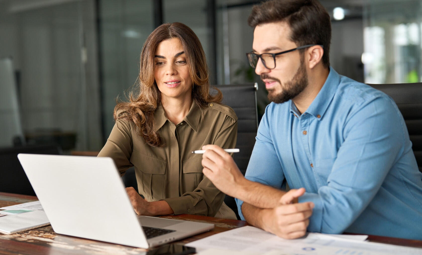 Two business professionals working together on a laptop